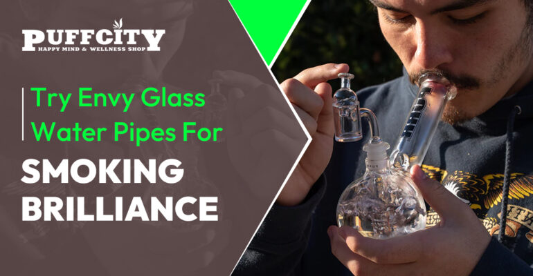 In this image, a boy is smoking through an envy glass water pipe. The background is green and brown with the PuffCity logo.