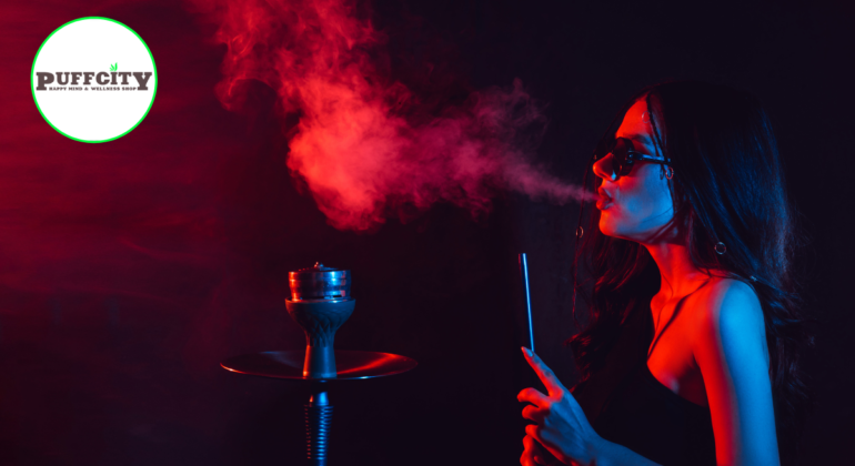 a elegant girl is puffing from glass water pipe in dark room or in black dress with blac glasses.